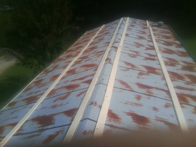 Rusted metal roof panels with new wood purlins before replacement — Storm Damage Roof Repair in San Juan Bautista by Roofing Brothers